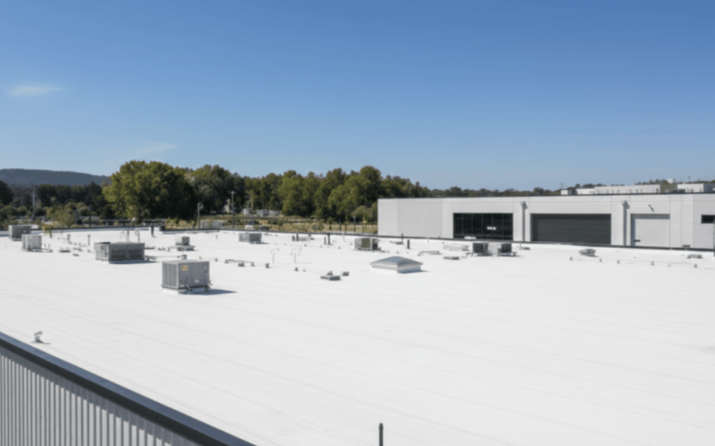 Commercial roofing services on industrial building.