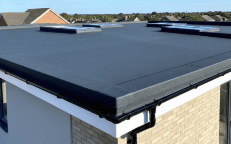 Flat roofing installation on residential building.